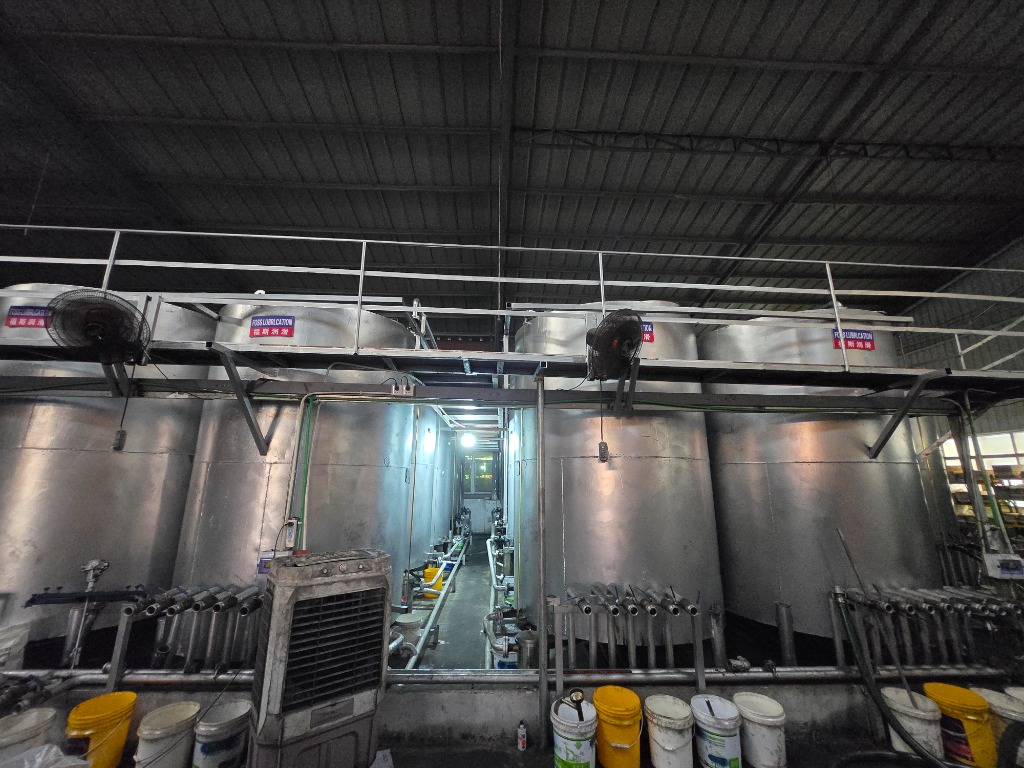 Interior corridor of automated formulation tanks maintaining ISO 9001 certified blending tolerances.
