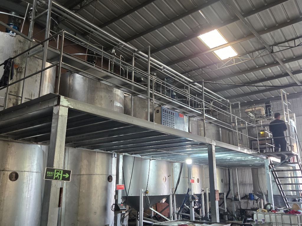 Two-level industrial mezzanine blending plant with electrical motor console and conical vessels
