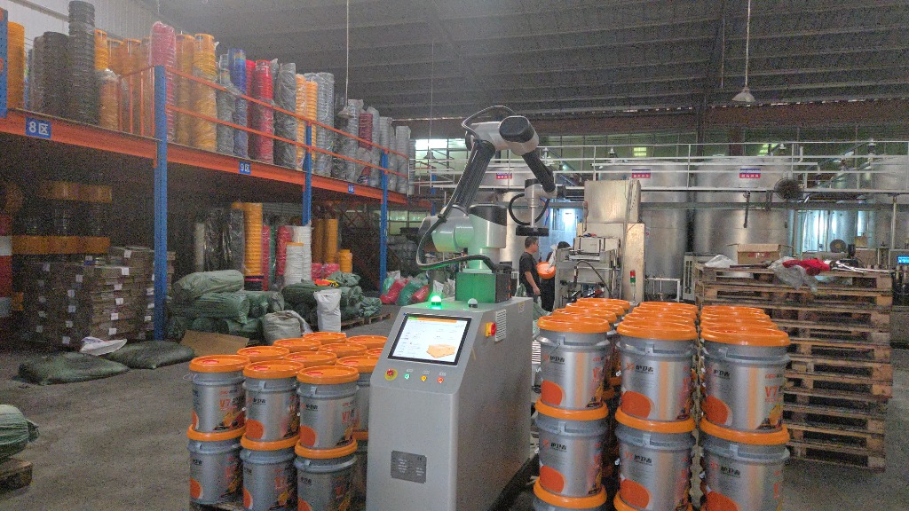 High-tech 6-axis robotic palletizing arm stacking lubricant pails onto wooden export pallets