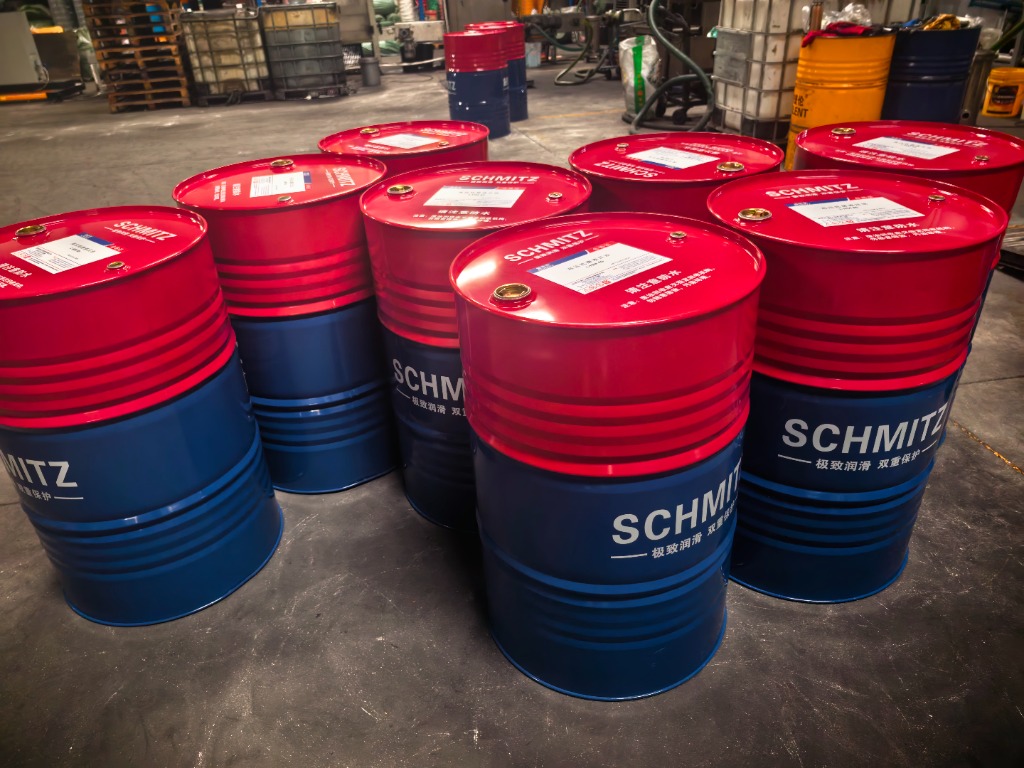 Lubricant blending and staging workshop floor with 208L steel drums and 1000L IBC totes